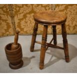 A 19th century stool with cross-form united turned legs, together with a treen 19th century pestle
