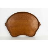 A Robert Thompson 'Mouseman' oak adzed top kidney shaped tea tray, with carved mouse signature in