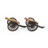 A pair of antique model cannons, in bronze and cast iron, 10cm high.