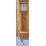 A pine long case clock, with painted enamel dial, having flowers to the spandrels and rolling date