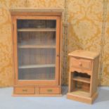 A large antique pine glazed cabinet with shelved interior and two lower drawers together with a