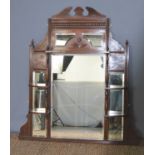 An Edwardian mahogany over mirror, with central bevelled glass panel flanked by two narrower