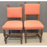 Two similar 19th century hall chairs with oak frames carved with lion head finials with barley twist