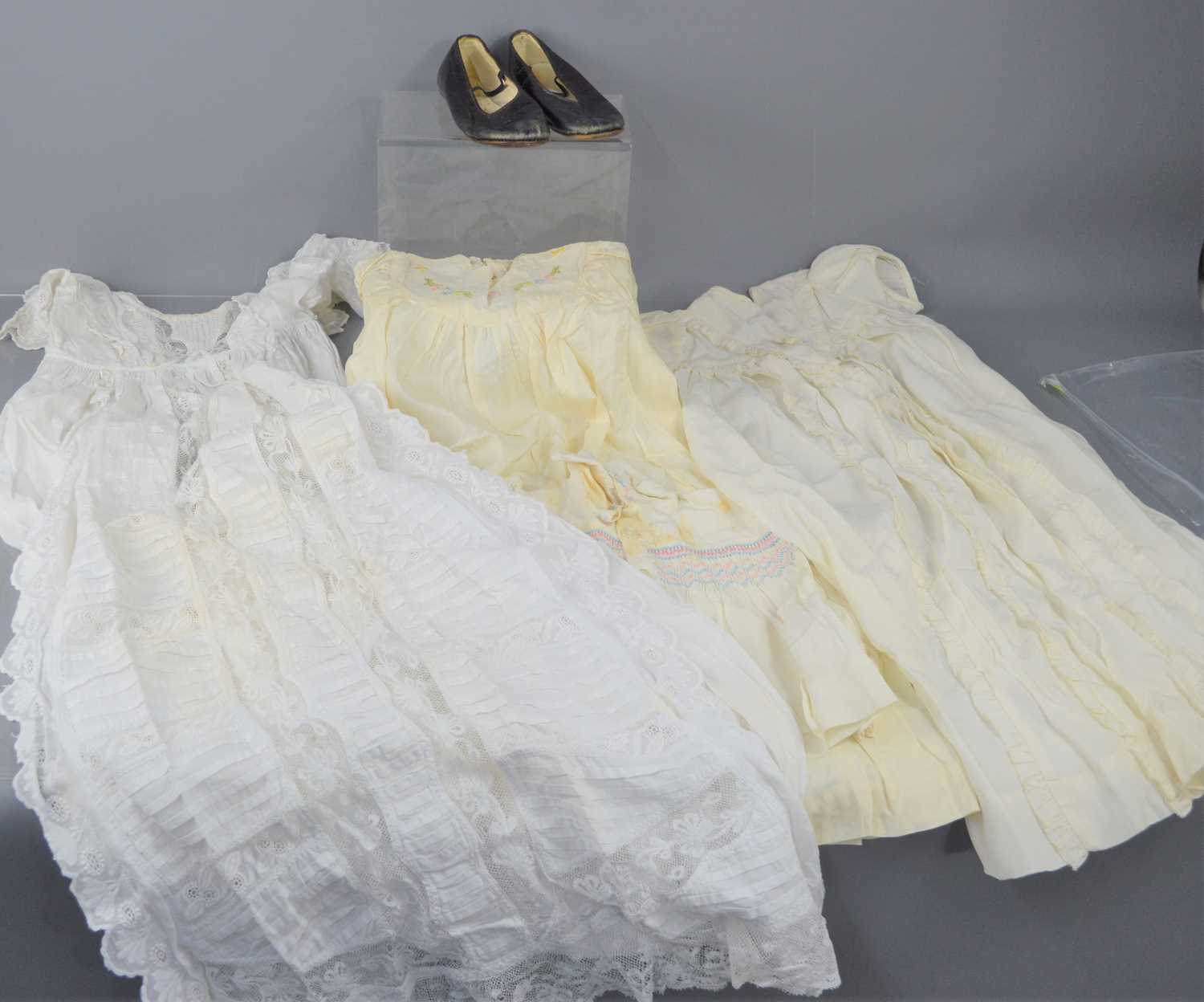 A group of vintage childrens clothing comprising a silk embroidered Christening dress, a turn of the