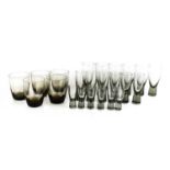 A group of Holmgaard glasses, three sets of six and one of five, of graduated sizes, in smoky