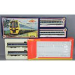 A boxed Bachmann OO gauge 158 DMU two car train set together with a Hornby Class 155 super