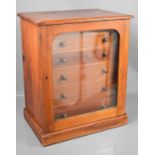 A 19th century mahogany collectors cabinet, with six slim drawers enclosed by a glazed door, 45 by