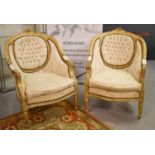 A pair of modern French style gilt wood armchairs upholstered in cream