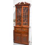 An Edwardian secretaire bookcase, the glazed upper section enclosing four height adjustable