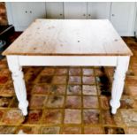 An antique pine kitchen table, with a grey painted base.