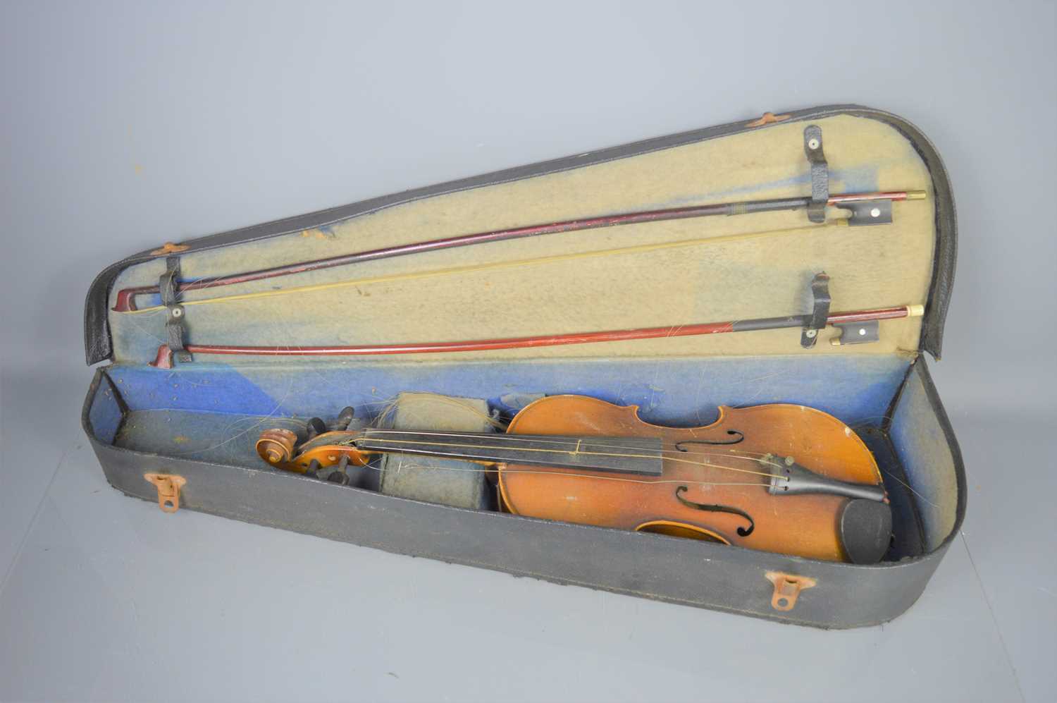 An early 20th century violin in hard case and with two bows, copy of Stradivarius label inside
