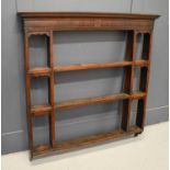 A 19th century oak and mahogany Delft / wall rack, with two shelves flanked by shelves with ogee