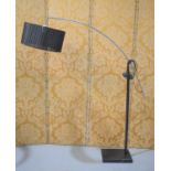 An arc form lamp standard in chrome with black marble base and black shade