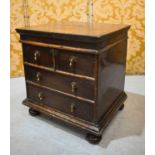 An 18th century oak box, with four faux drawers to the front and hinged lid, raised on squat bun