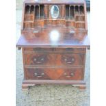 A 20th century mahogany inlaid bureau, the full front enclosing a fitted interior, raised on bracket