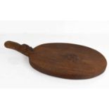A Robert Thompson 'Mouseman' dark oak cheese board, carved with trademark mouse, 39cm long.