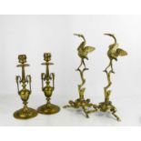 A pair of brass Empire style candlesticks and two stands in the form of cranes, 31cm high.