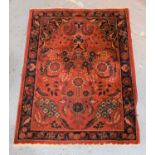 A Samarkland red ground rug with stylised border, 67cm by 91cm.