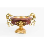 An Italian gilt bronze and red marble tazza, with twin handles cast in the form of dragon heads,