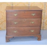 An early 19th century oak chest of three drawers raised on bracket feet 88cm high by 96cm by 56cm