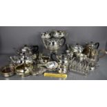 A group of silver plateware to include two three-piece tea sets, a toast rack, dressing table vanity