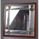 A white metal Italian mirror, with hammered panels and embossed decoration, Fl Ag 3g 1137.