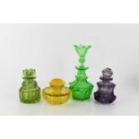 Four vintage coloured glass dressing table bottles of different form, tallest 17cm high.