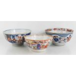 Three Chinese porcelain bowls, one decorated with figural scenes, the others in blue and red with