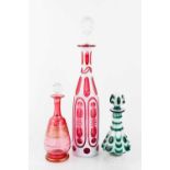 Three pieces of bohemian glass, two in cranberry glass, and one in opaque white and green glass,