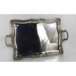 A large 100 grade silver tray, of rectangular form, embossed to the borders with scrollwork,