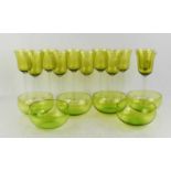 A set of eleven mid century green wine glasses and six matching bowls.