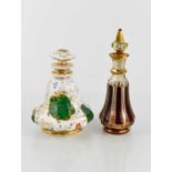 Two Victorian dressing table bottles, one in porcelain with painted flowers and gilded highlights,