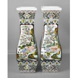 A pair of 20th century Chinese vases of square baluster form, decorated with garden scenes, exotic