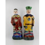 Two large Chinese stoneware polychrome figures, each in courtly costume, their robes with roundles