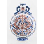 A Chinese moon flask, in blue white and red, decorated with scrolling foliage, bats and butterflies,