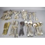 A group of silver and silver plated flatware, including basting spoons, knives, forks and other