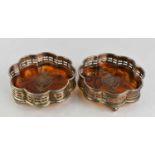 A pair of silver plate and faux tortoiseshell wine coasters, with ball feet, 12cm diameter.