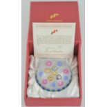 A limited edition Perthshire PP11 glass millefiori paperweight, multiple florettes on white