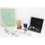 A group of commemorative coins to include a Barbados Lady of the Century silver dollar.