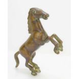 A Chinese bronze rearing horse, 16cm high.