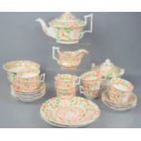 A Victorian part tea service in a green and red floral pattern.