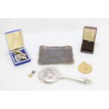 A silver hand mirror together with a small group of vintage costume jewellery and other items.