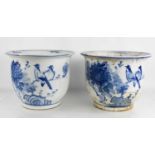 A pair of Chinese blue and white jardinieres, depicting birds and peonies, 24cm high.