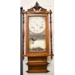 A 19th century marquetry inlaid wall clock, with Roman numeral dial, mirrored back, and the glazed