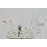 A collection of Swarovski silver crystal animal figurines together with three glass swans and a