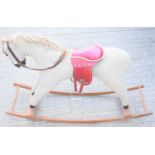 A vintage straw filled rocking horse, with red patent leather saddle.