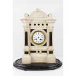 A 19th century portico mantle clock, in carved stone in the Italian style, with a Roman numeral
