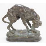 A bronze sculpture of a dog with a bone, likely French 19th century Animalier school, apparently