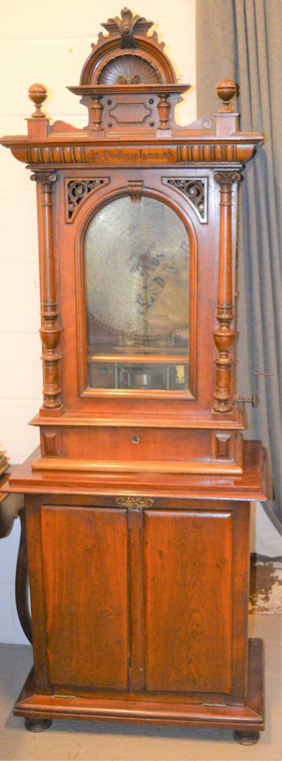 A late 19th century mahogany cased "Penny in the Slot" Polyphon music box on associated mahogany
