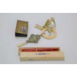 A Victorian baby teether together with a boxed Dinkie pen and matchbox holder.